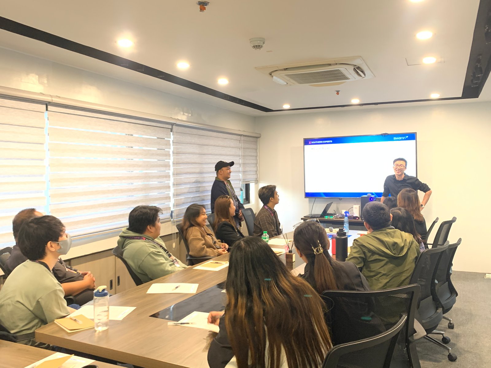 The SX team discussing work together in a meeting room